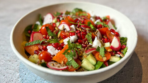 Spinach, butternut and quinoa salad . The fresh spinach, tomatoes and cucumber work so well with the warm butternut and quinoa, and there's that added bonus with citrus bursts of pomegranate!