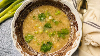 Delicious Chicken Sweetcorn Soup, with spring onion and coriander. Perfect for those fall days when you need comfort food. It's also super healthy and packet with protein. Creamy and Delicious!