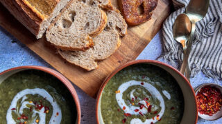 Spinach and potato soup, served with plain yogurt, chili flakes, and fresh ciabatta bread. This healthy soup is packed with flavor and leaves you wanting more.